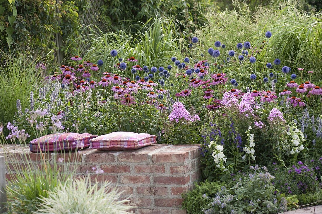 Perennial flowerbed behind brick wall