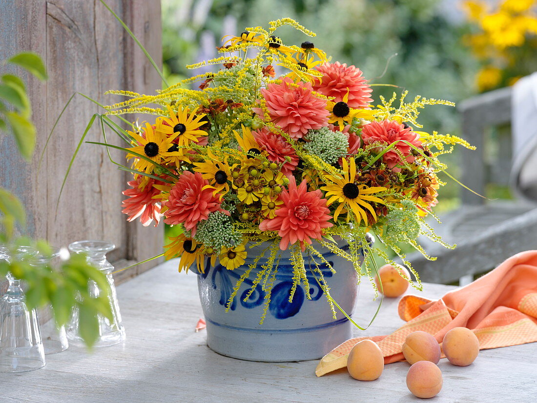 Yellow-orange bouquet from the cottage garden in glazed pots
