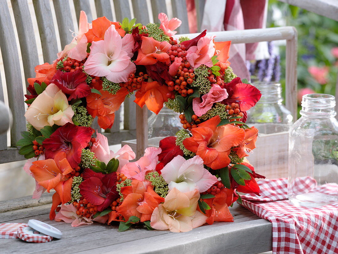 Late summer wreath made of gladioli, rowan berries and sedum