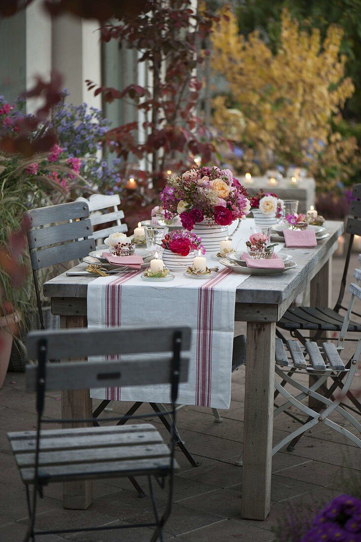 Autumnal rose table decoration on the terrace