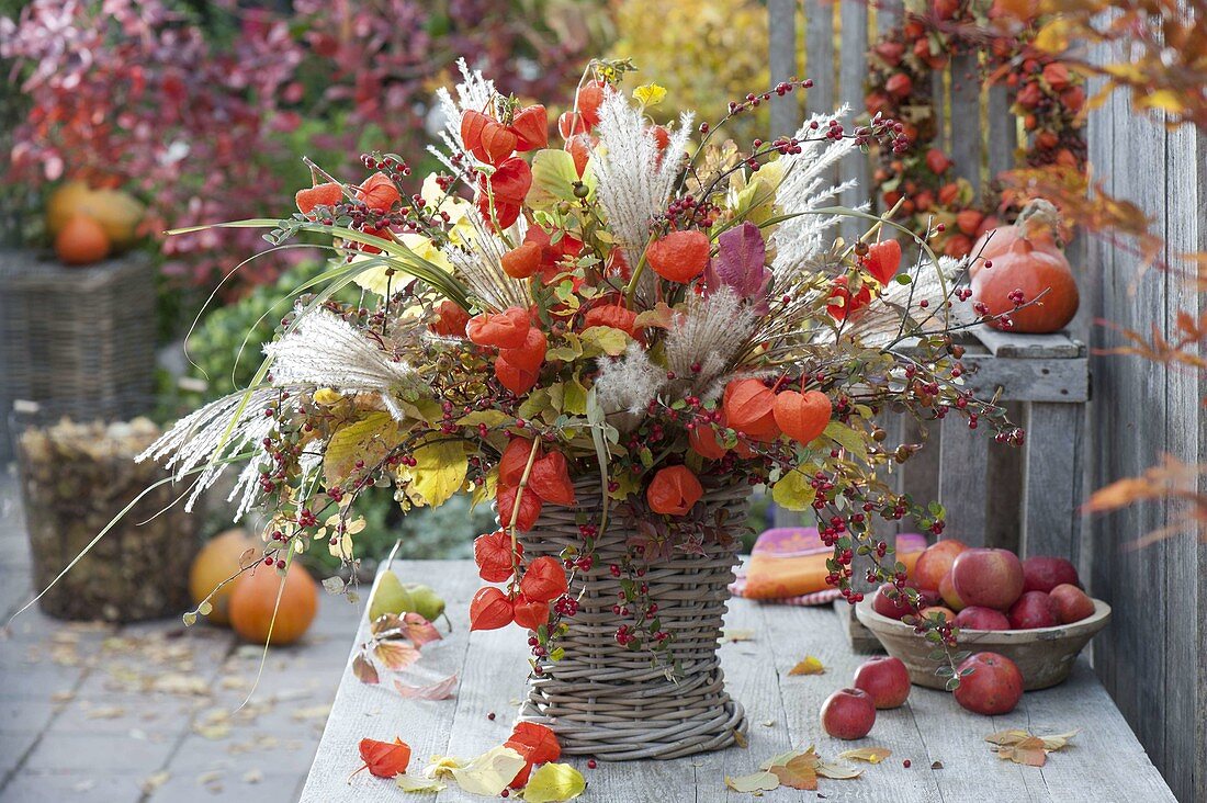Autumn bouquet with physalis, miscanthus, cotoneaster