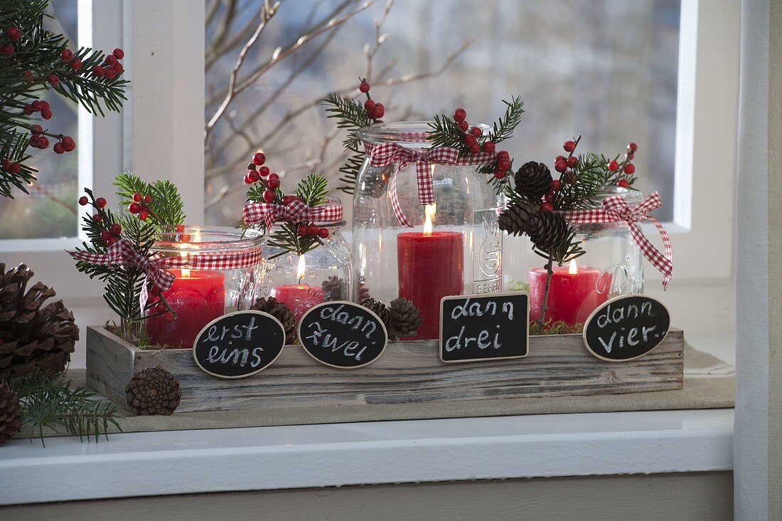 Unusual Advent wreath in preserving jars on wooden coasters