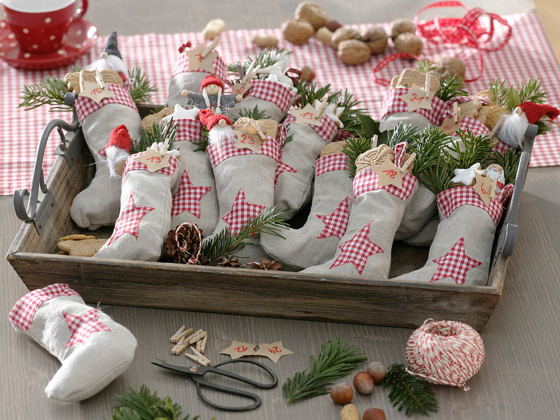 Advent calendar made of stuffed fabric ankle socks on a wooden tray