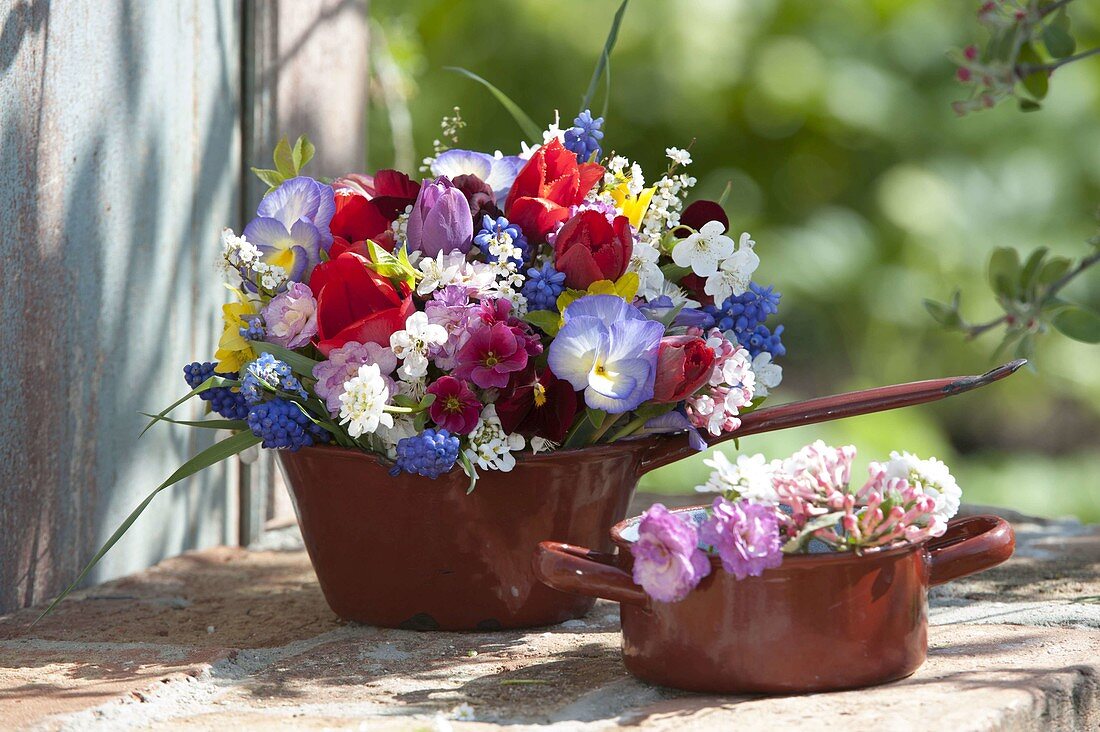 Colorful spring flowers in enamel pots