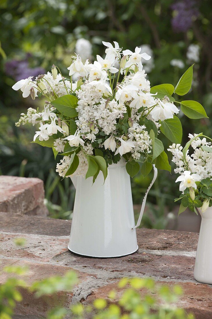 White bouquet of syringa (lilac) and aquilegia (columbine)