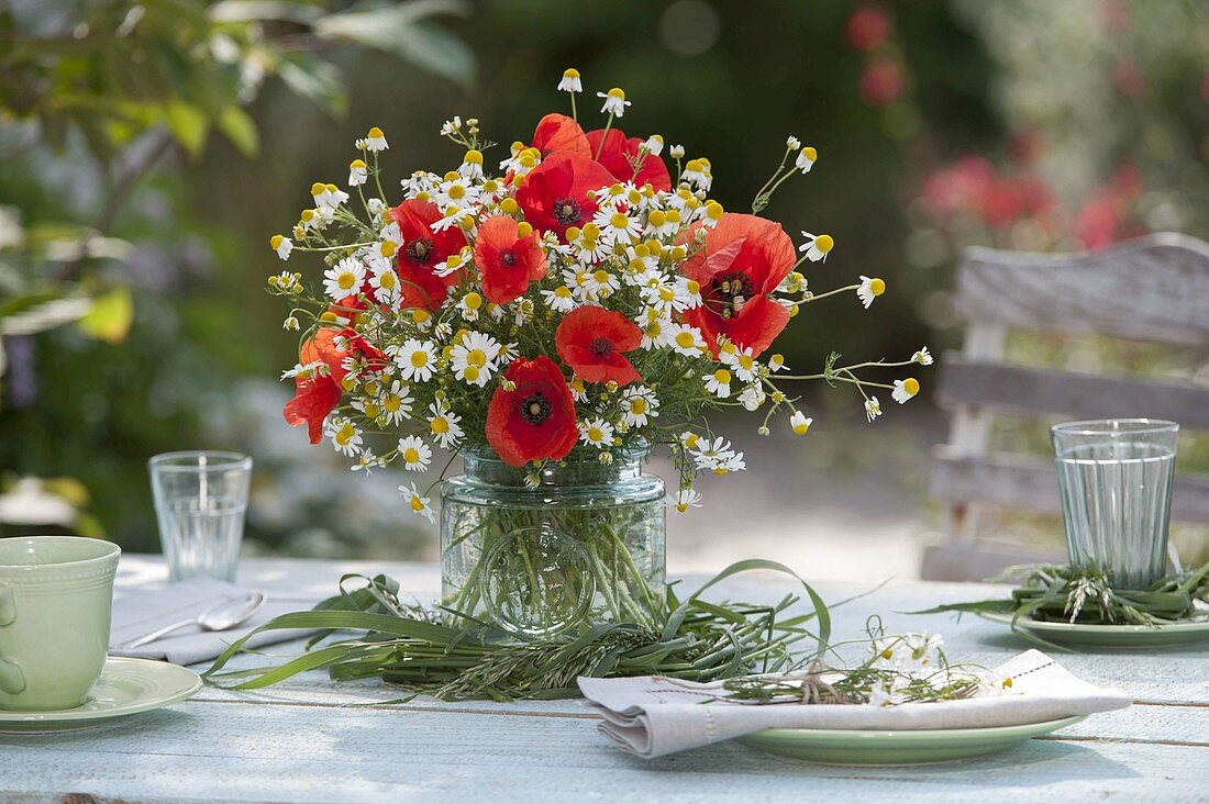 Red and white meadow bouquet with Papaver rhoeas and Matricaria
