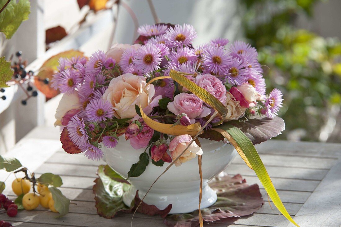 Bouquet with Rose, aster and leaves of Bergenia