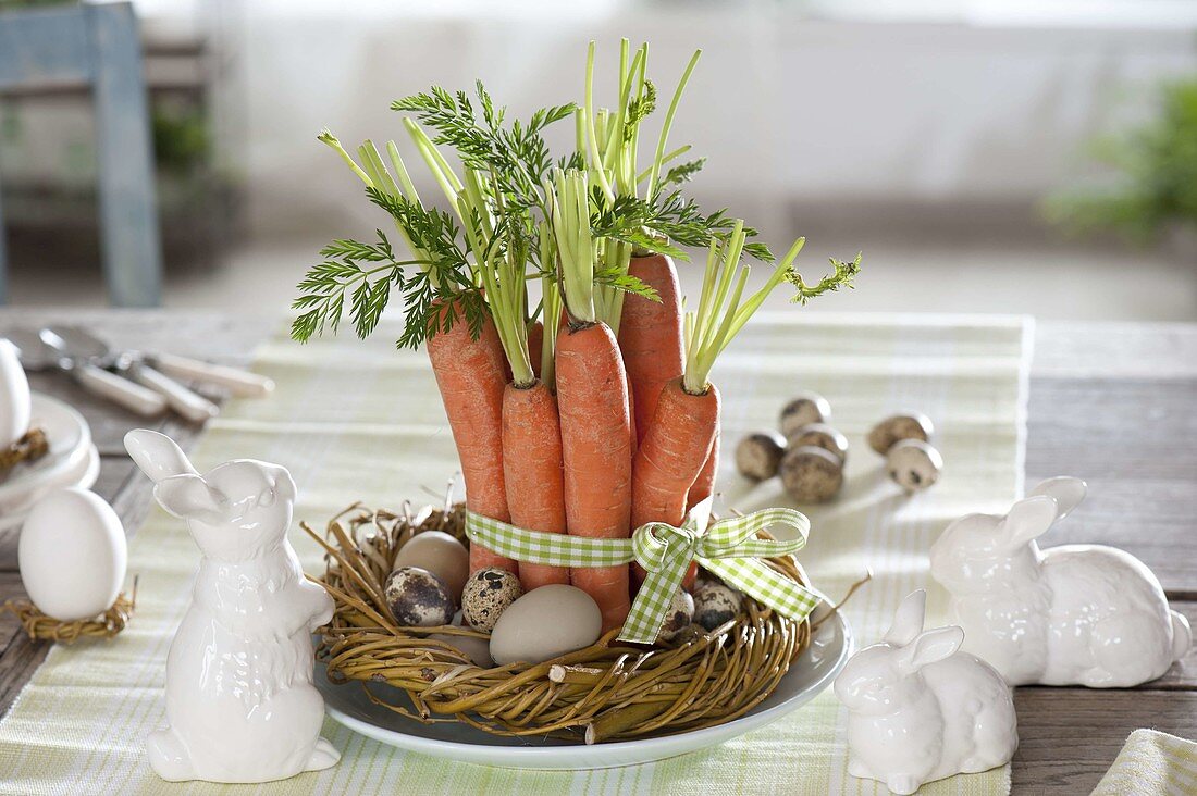 Easter basket with carrots and eggs, ceramic bunnies