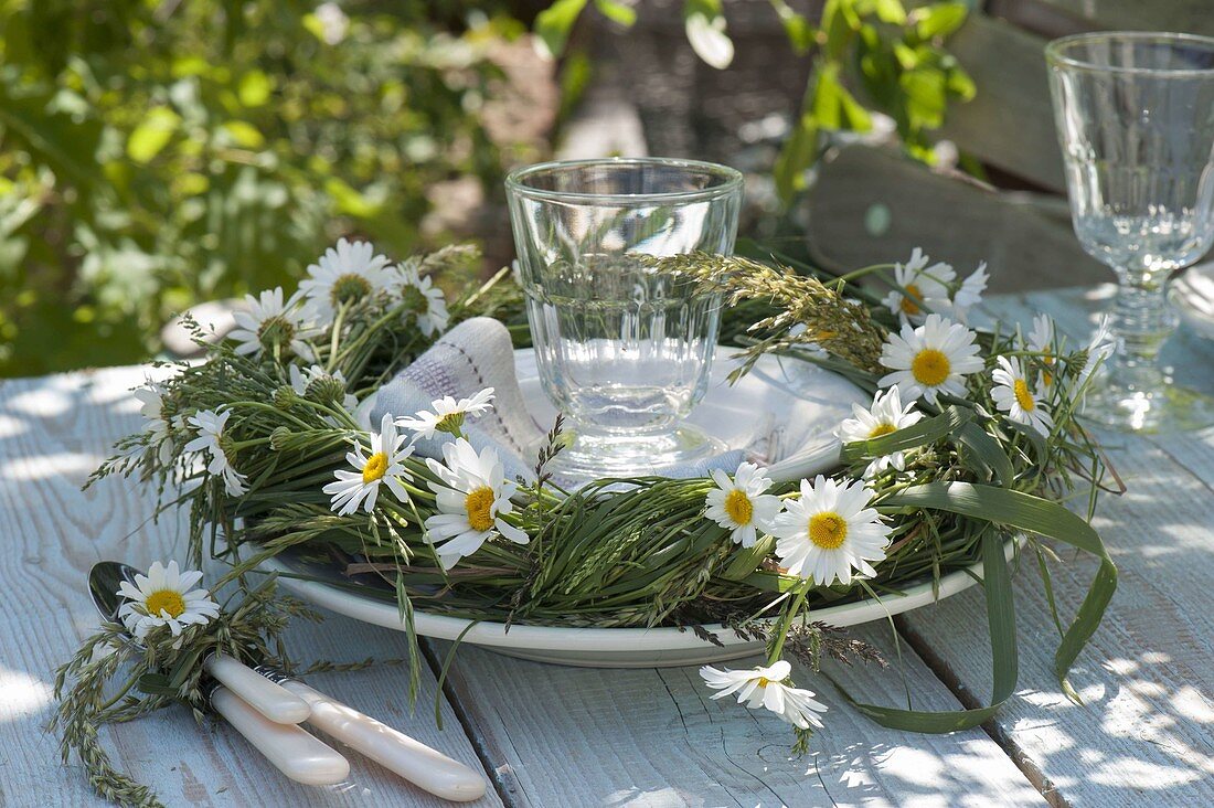 Wreath of grasses from the meadow, decorated with Leucanthemum vulgare