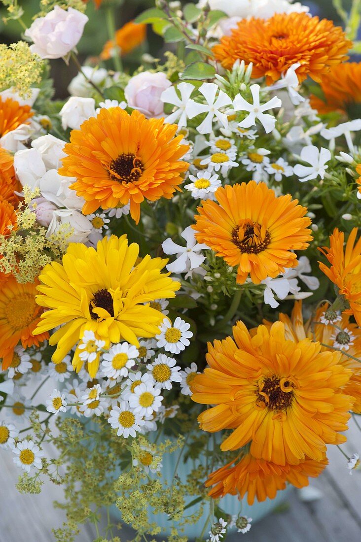 Orange and white bouquet with marigolds