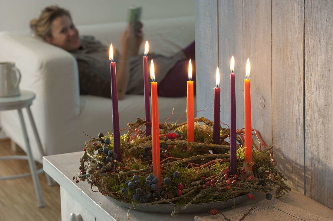 Wreath made of natural materials with candles on zinc-