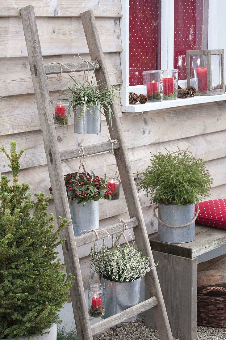 Old wooden ladder with tin pots and lanterns