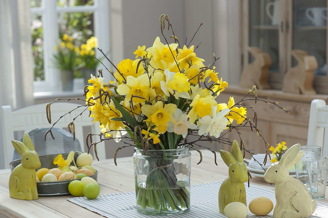 Easter bouquet with narcissus and betula in wide glass