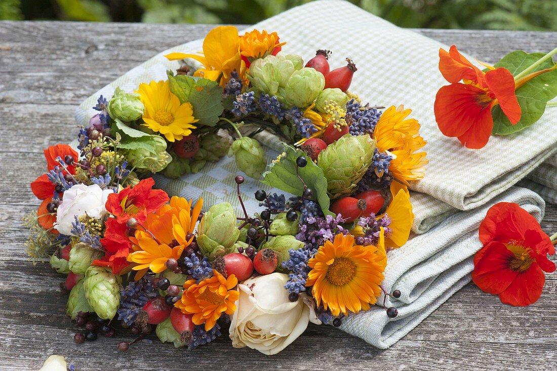 Small edible flowers wreath, tea herbs and wild fruits