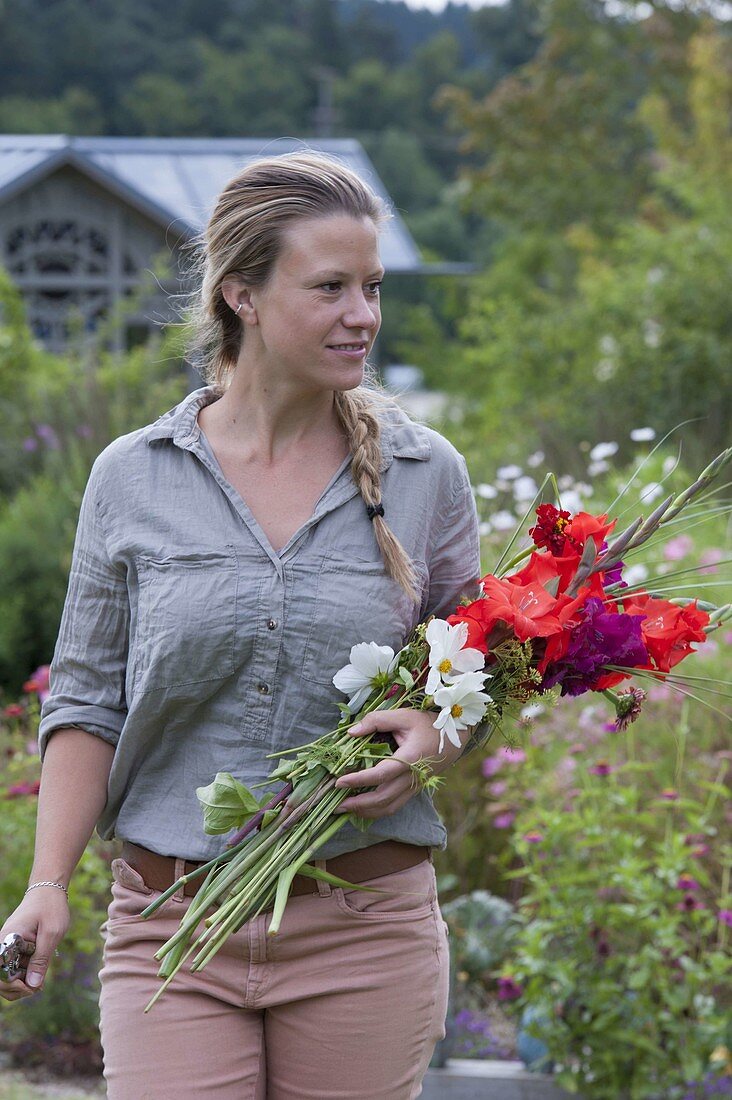 Woman with fresh cut flowers for bouquet