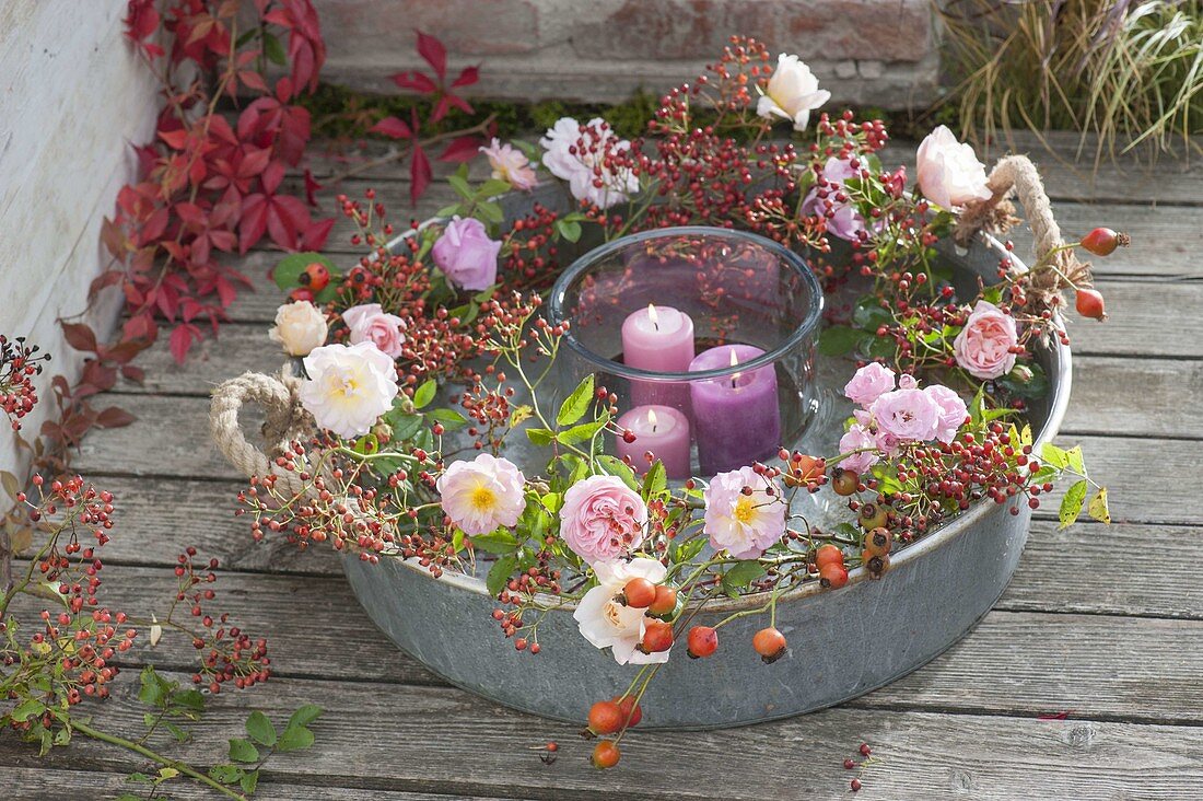 Pink wreath in zinc tray with water, lantern