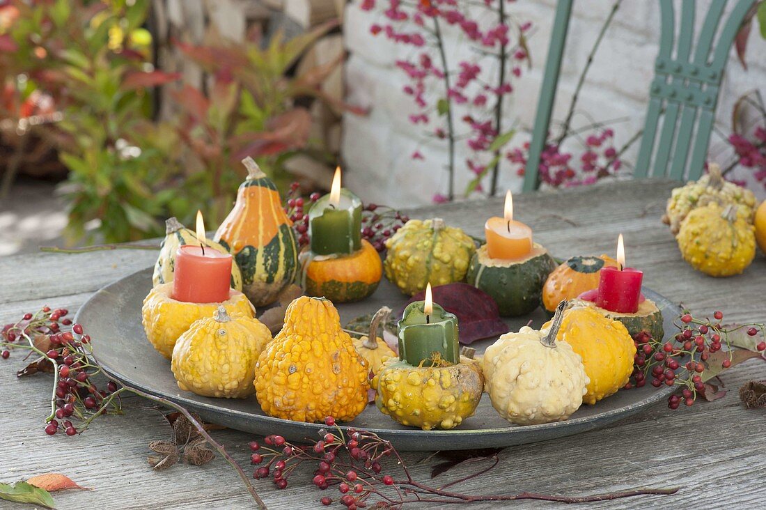 Tray of ornamental gourds and candles