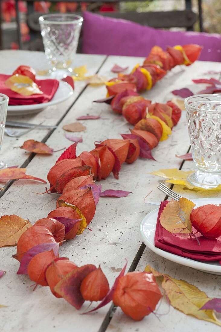 Autumn table decoration with lanterns and autumn leaves