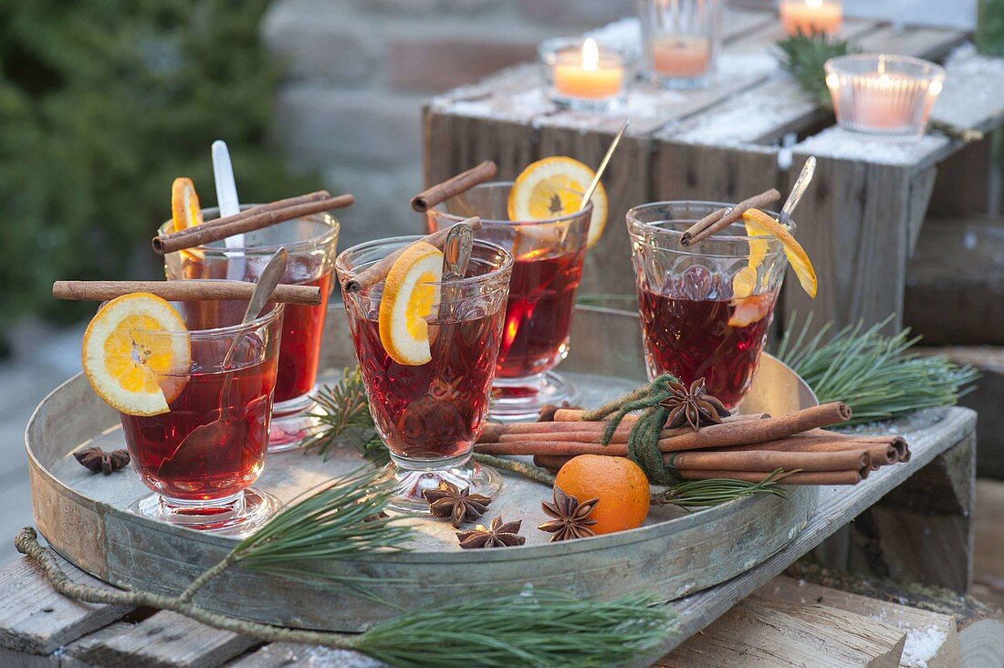 Glasses with punch, slices of orange, cinnamon sticks, star anise