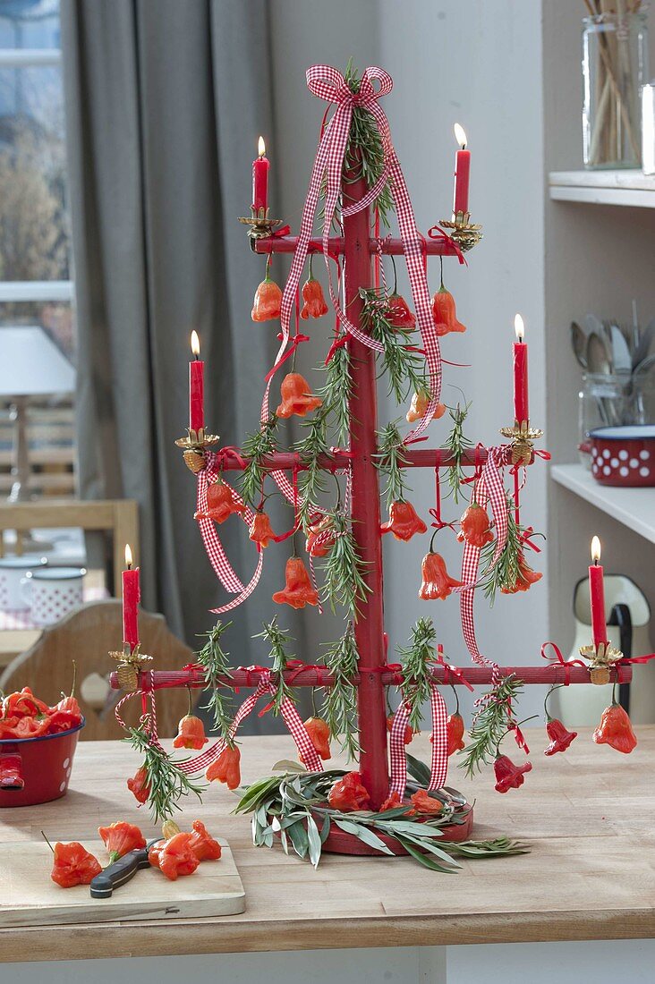 Wooden frame as a stylized fir tree, decorated with bell peppers