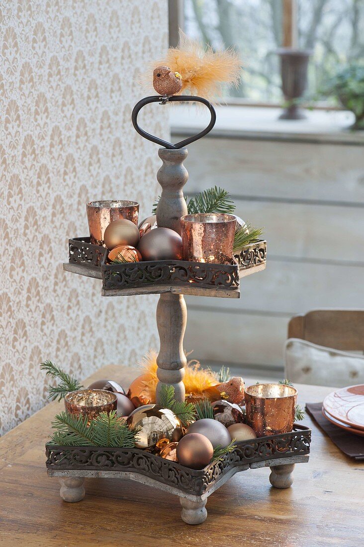 Metal etagere with copper-colored lanterns, glassbirds