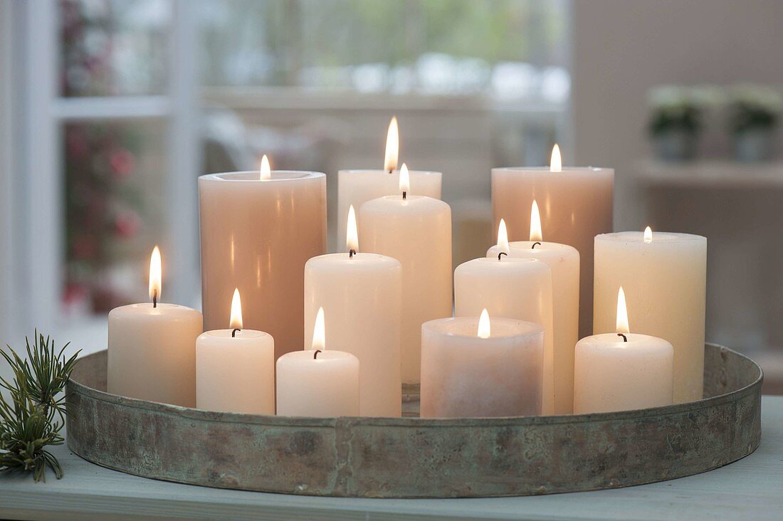 Metal tray with white candles