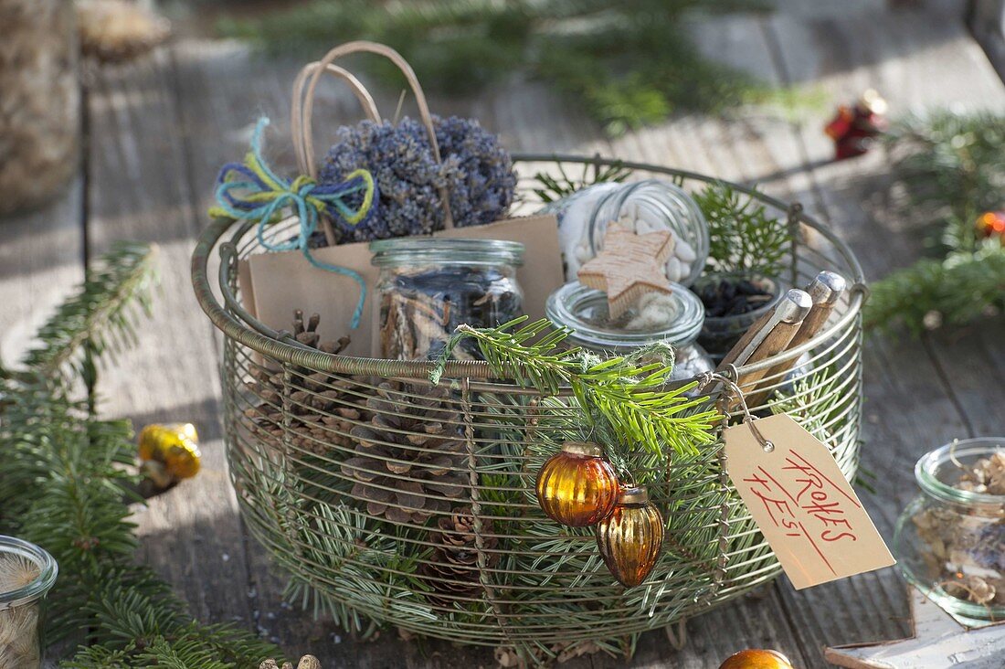 Wire basket with cones, abies branches, jars with seeds