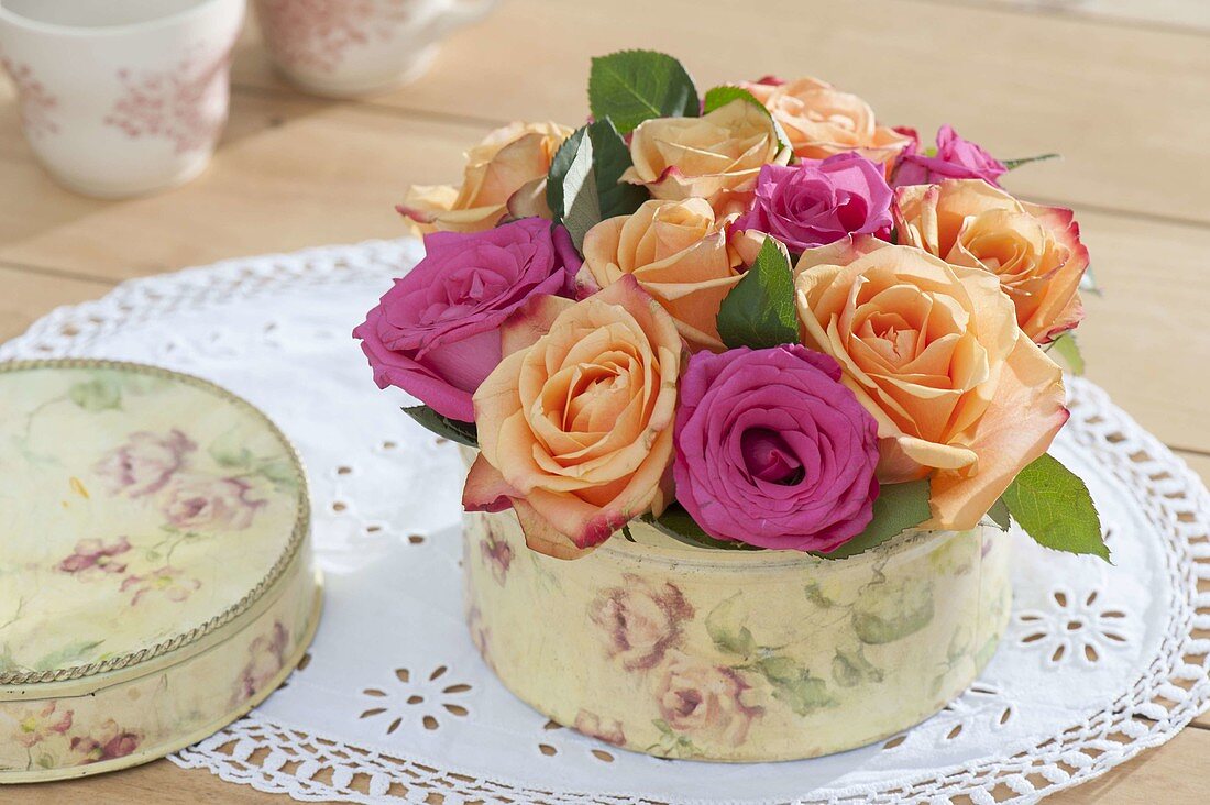 Kleine Blumentorte aus Blüten von Rosa (Rosen) in Keksdose