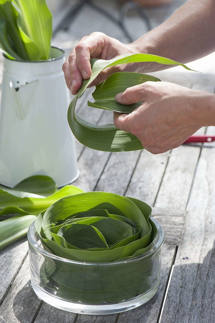 Table arrangement of corn leaves in glass bowl