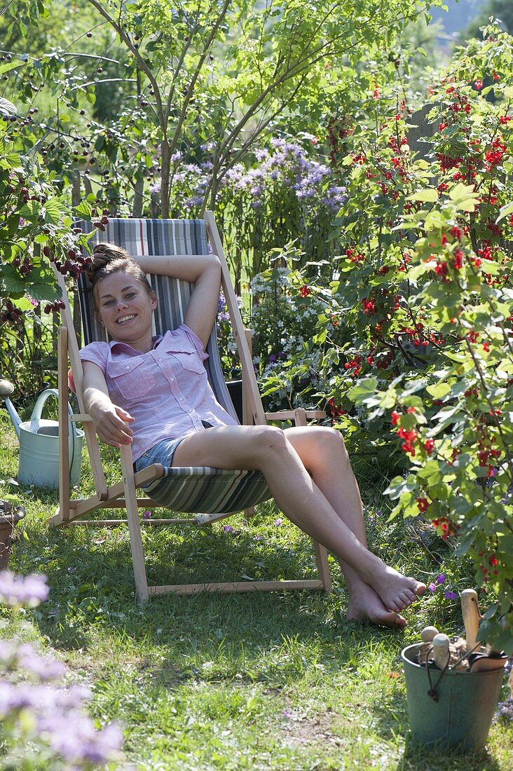 Woman enjoying the summer in the garden