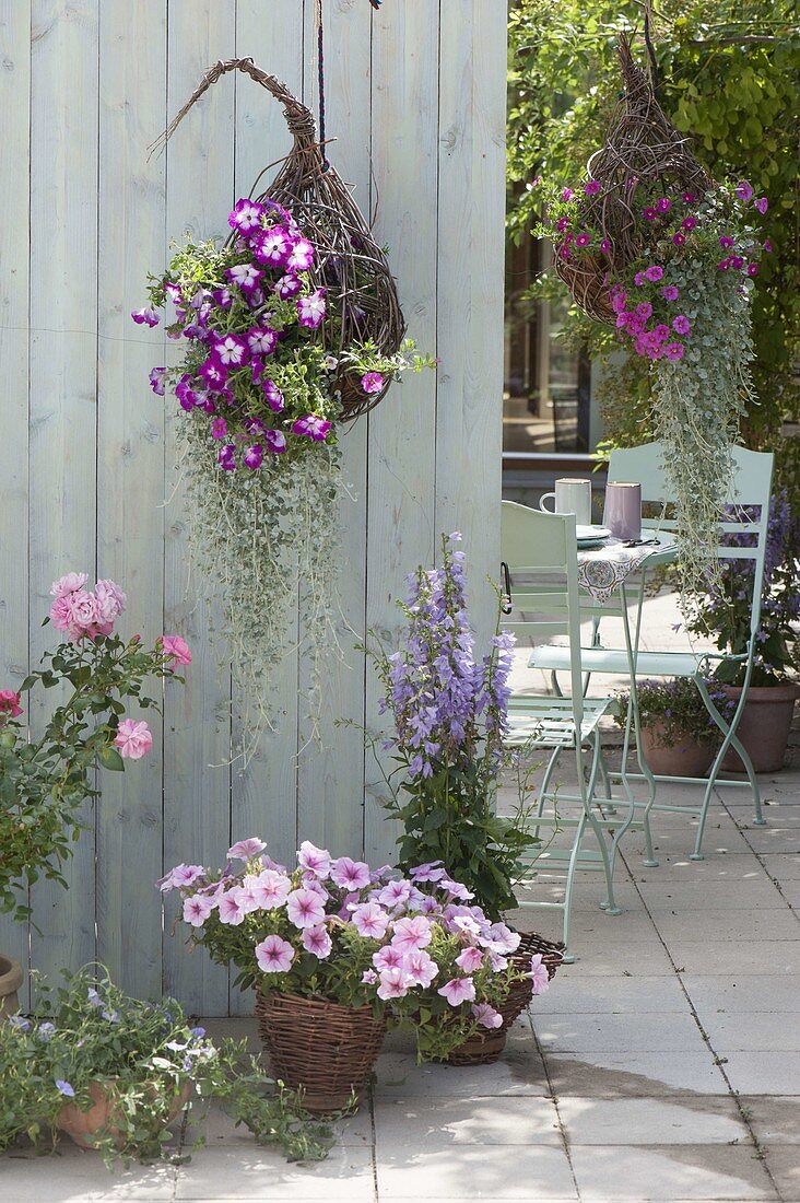 Terrace with homemade flower baskets and willow pots