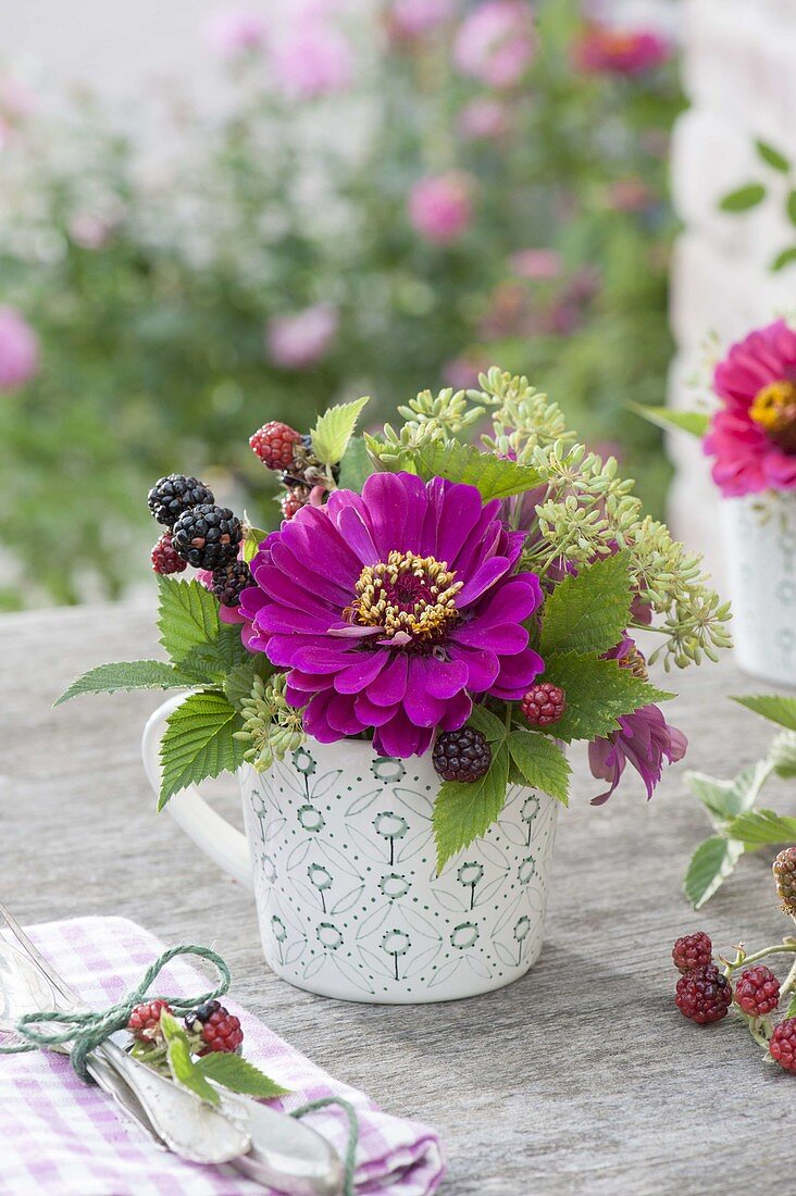 Mini-bouquet in cup with Zinnia (Zinnia), Blackberries (Rubus)
