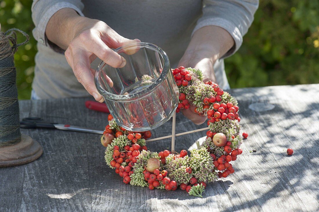 Wreath made of rowan berries, ornamental apples and stonecrop