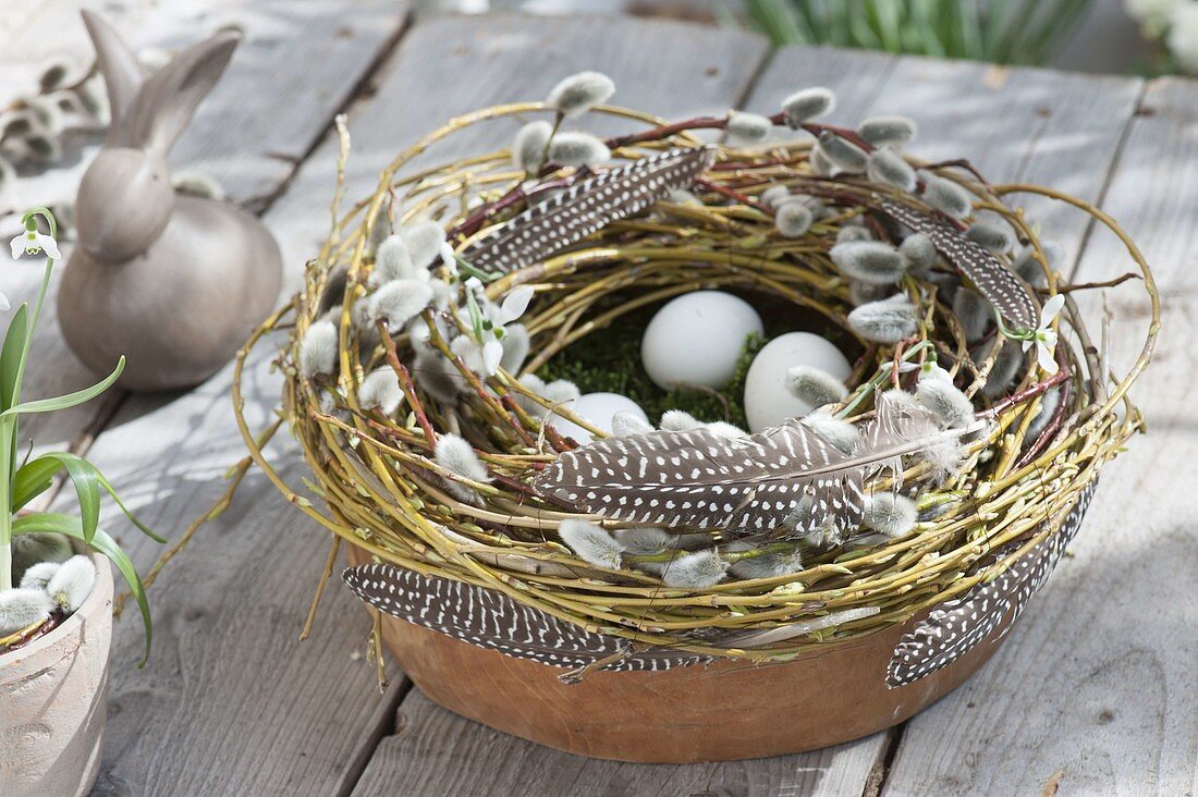 Clay bowl with wreath of Salix (willow, kitten willow) and feathers