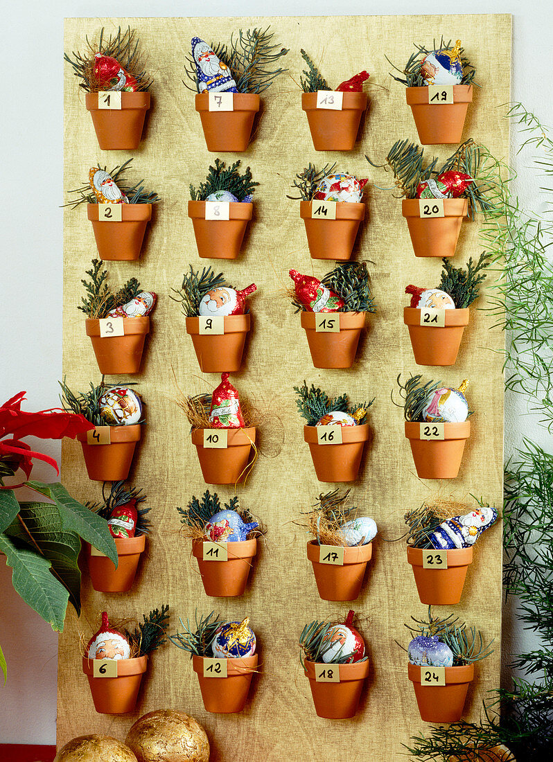Advent calendar with clay pot wooden board stuck with clay pots
