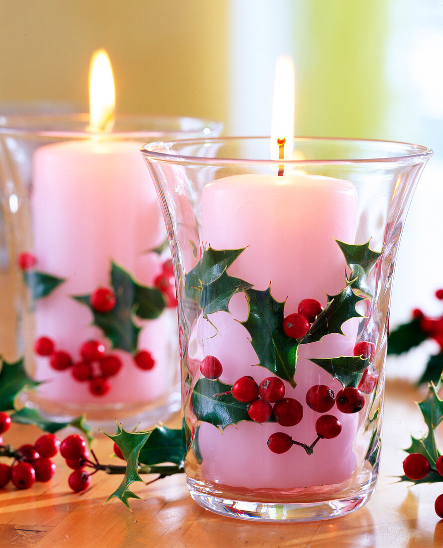 Ilex 'Alaska' (holly) leaves and berries, glasses with candles