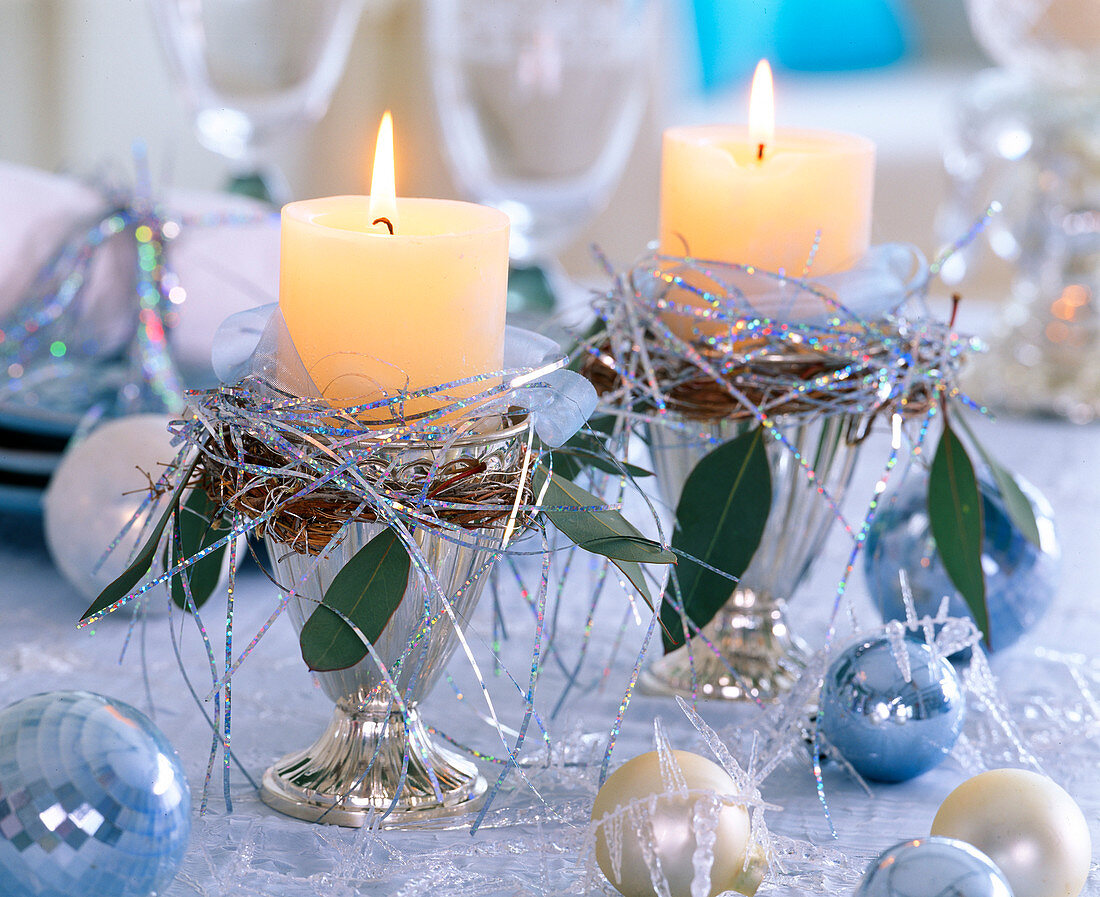 Silver ice cream cup with candle, tinsel and balls