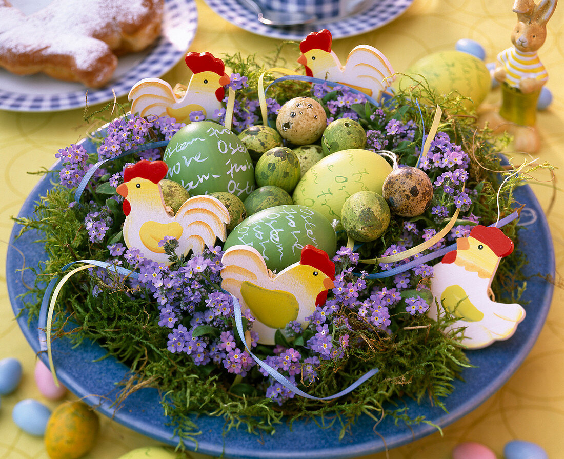 Easter nest with moss, myosotis (forget-me-not)