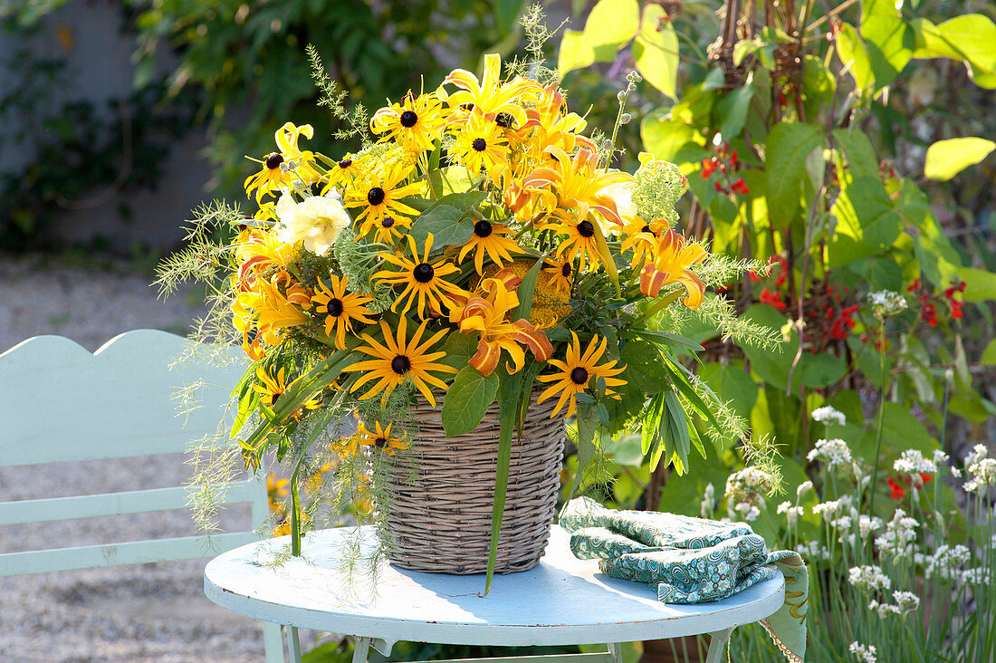 Yellow summer bouquet in basket vase, Rudbeckia fulgida