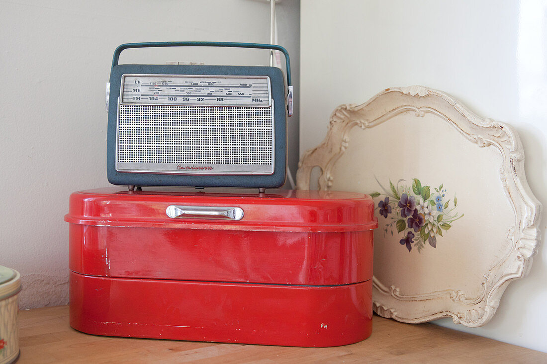 Old radio on red bread bin