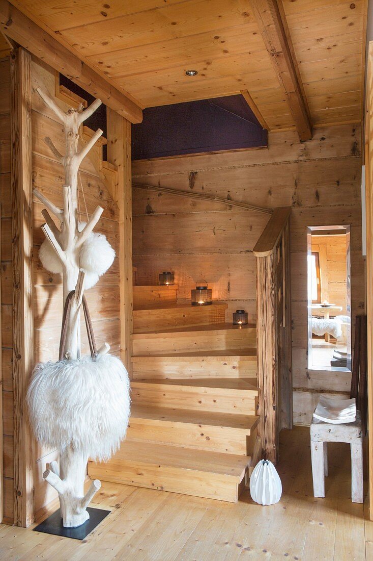 Staircase, tree-style coat rack and fur shoulder bags in dacha