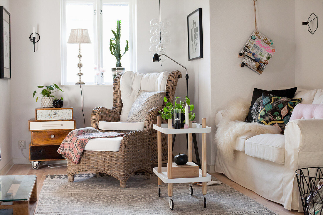 Wicker armchair and sofa in cosy living room