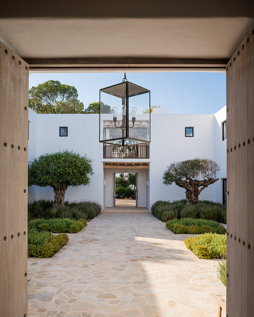 View into Mediterranean courtyard through open doors