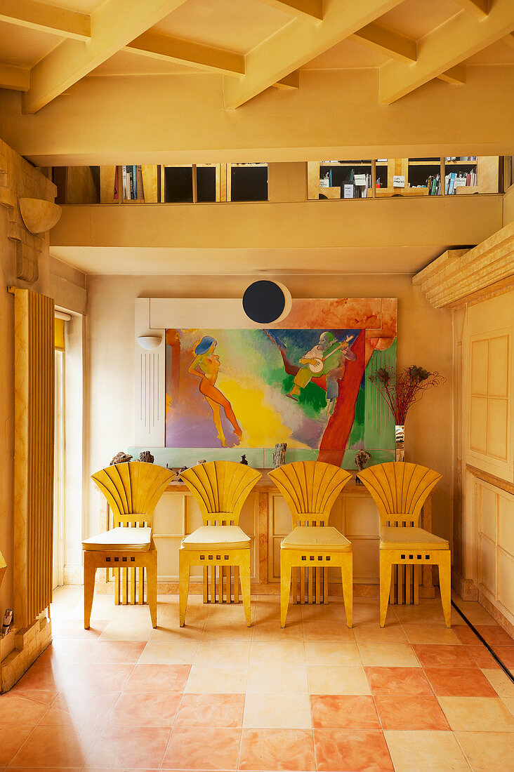 Designer sunburst chairs and modern painting in hallway
