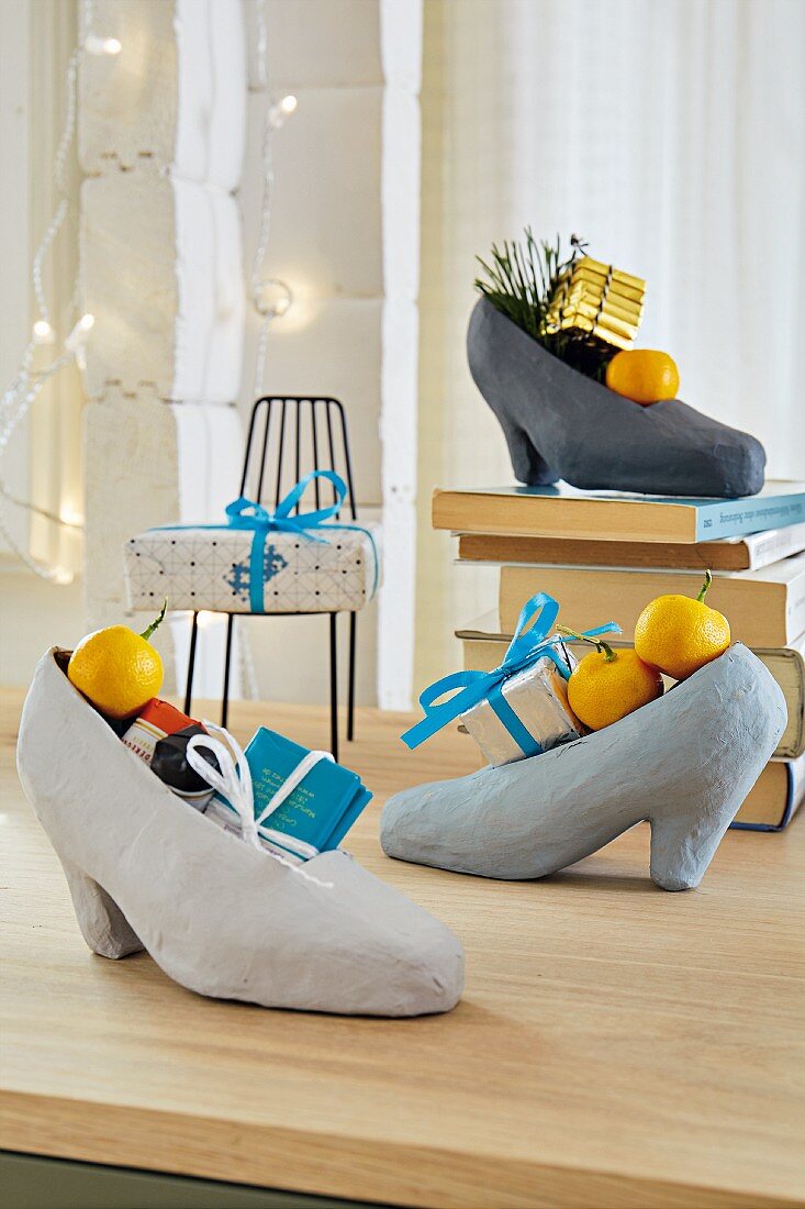 Ladies' papier-mâché shoes filled with small Christmas gifts