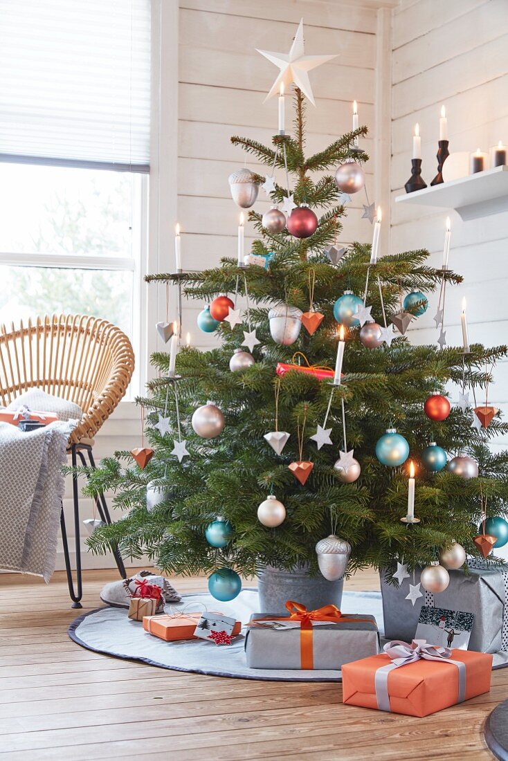 A Christmas tree with modern decorations and candles