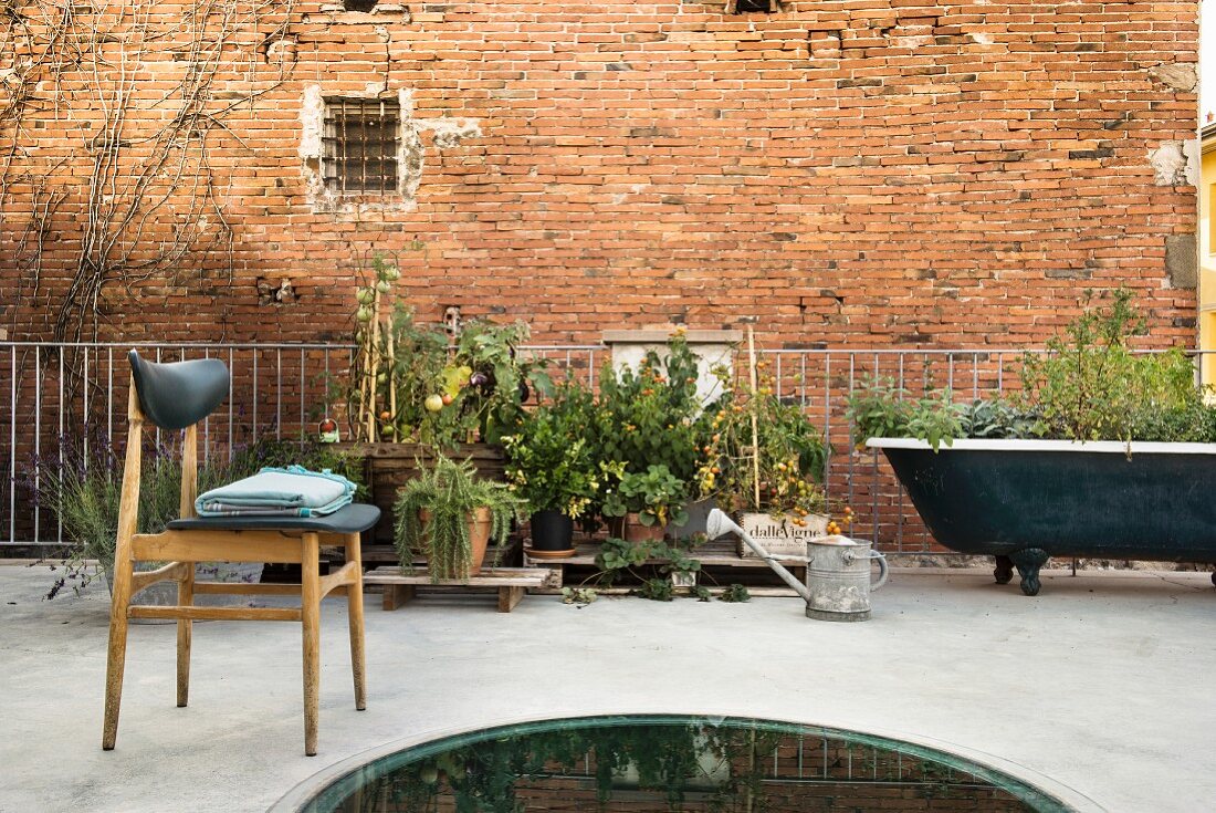 Urban, vintage-style roof terrace with brick façade