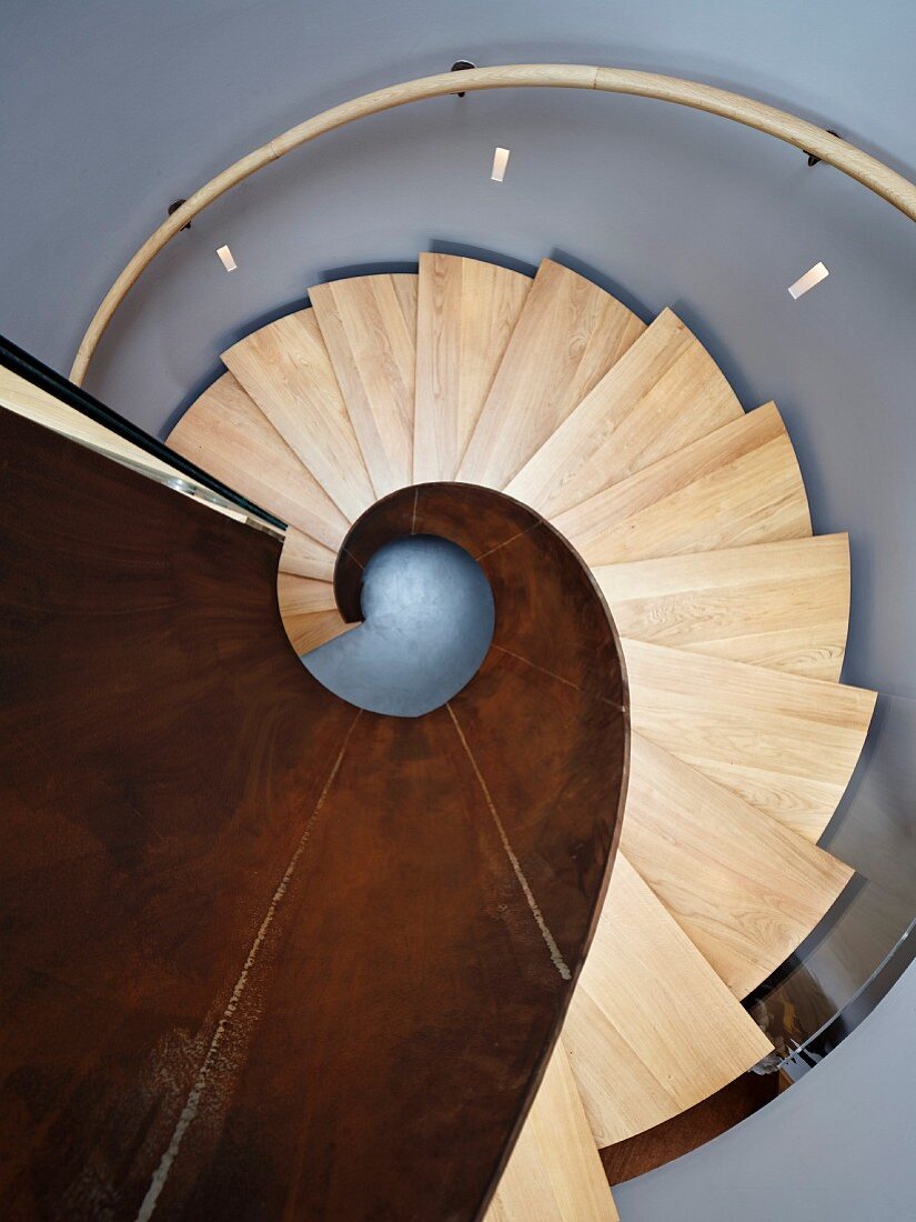 View down spiral staircase made from metal and wood