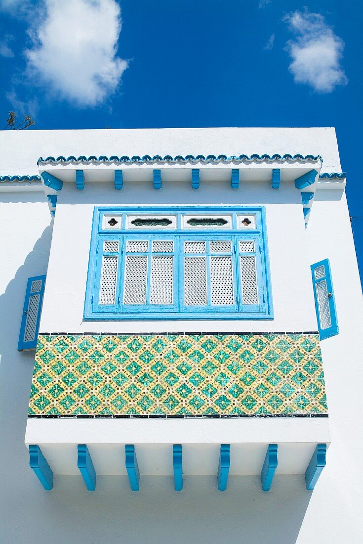 White and blue Tunisian facade with ornate bay window