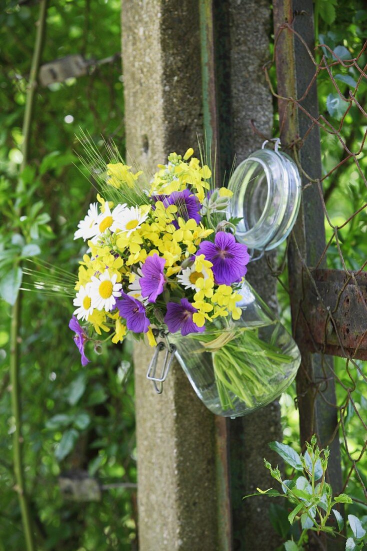 Cottage garden flowers and ears of cereal in preserving jar